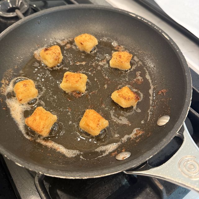 Gnocchi browning in butter in a nonstick pan